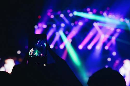 leisure activities person taking photo of concert lighting